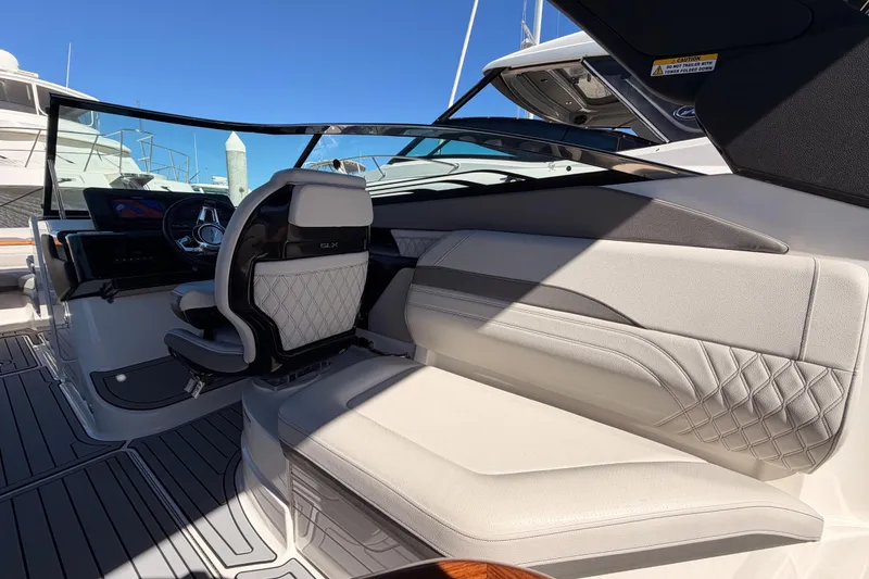Slide: The Image of 2024 Sea Ray SLX 260 boat interior with luxurious seating and modern dashboard. - 17