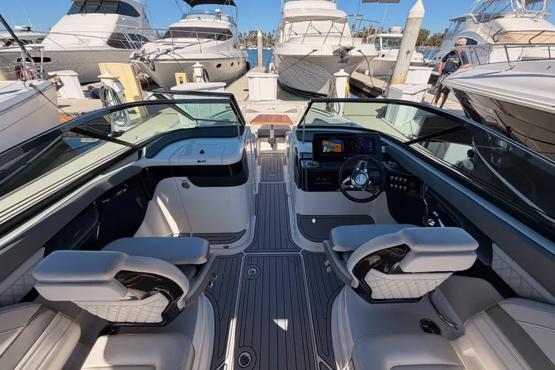 Slide: The Image of 2024 Sea Ray SLX 260 boat interior with modern dashboard and luxurious seating. - 18