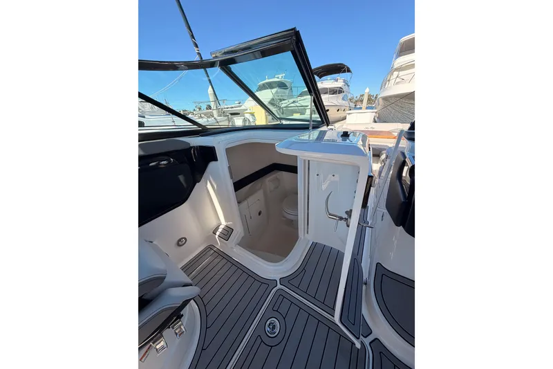 Slide: The Image of 2024 Sea Ray SLX 260 boat interior with open door, showcasing sleek design and modern features. - 22