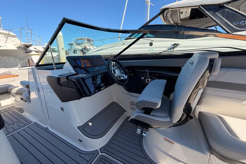 Slide: The Image of 2024 Sea Ray SLX 260 boat interior with modern helm and seating. - 25