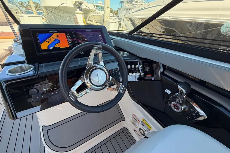 Slide: The Image of 2024 Sea Ray SLX 260 helm with modern controls and navigation display. - 26