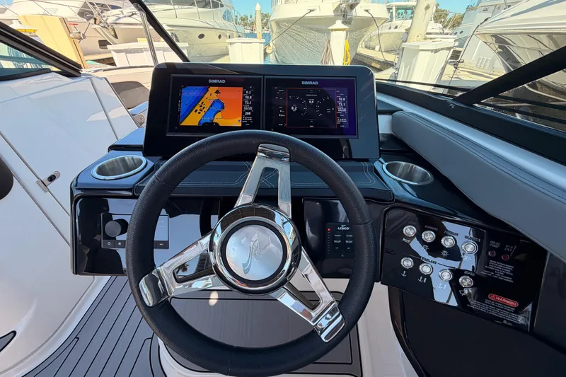 Slide: The Image of 2024 Sea Ray SLX 260 helm with modern controls and dual Simrad displays. - 27