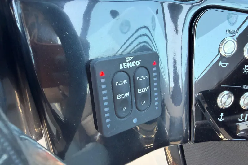 Slide: The Image of Control panel of 2024 Sea Ray SLX 260 boat with Lenco trim tab switches. - 29