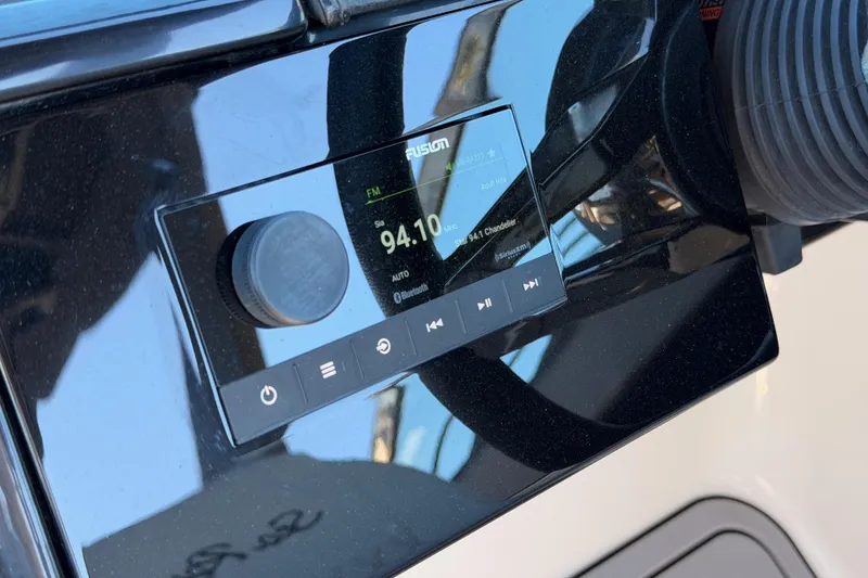 Slide: The Image of 2024 Sea Ray SLX 260 boat dashboard with Fusion audio system display. - 30
