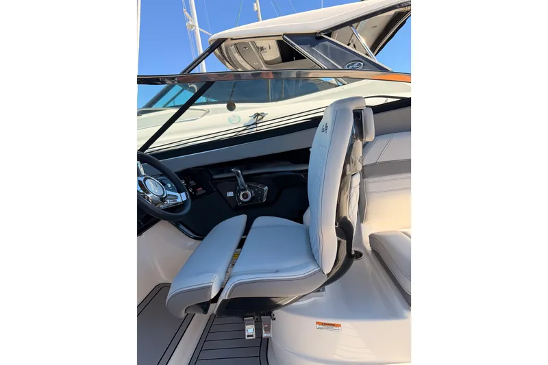 Slide: The Image of 2024 Sea Ray SLX 260 helm with modern steering and comfortable seating. - 33