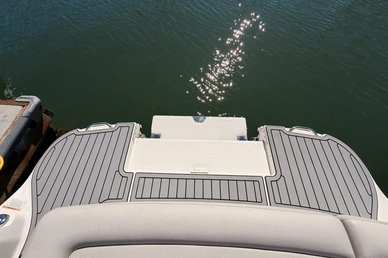 Slide: The Image of 2024 Sea Ray SLX 260 swim platform with sunlit water reflection. - 42