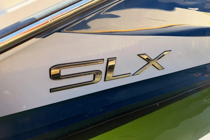 Slide: The Image of 2024 Sea Ray SLX 260 boat logo on sleek blue and white hull. - 43