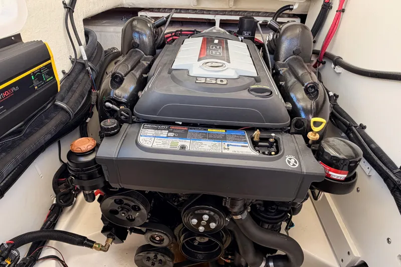 Slide: The Image of 2024 Sea Ray SLX 260 engine compartment featuring a powerful Mercury 350 engine. - 46