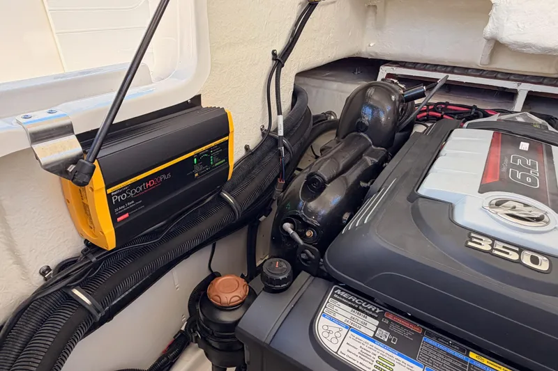 Slide: The Image of Engine compartment of 2024 Sea Ray SLX 260 with ProSport HD20 Plus charger. - 47