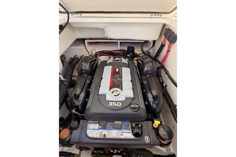 Slide: The Image of Engine compartment of 2024 Sea Ray SLX 260 boat, featuring a Mercury 350 engine. - 49