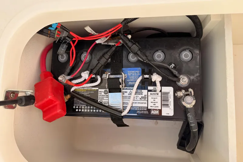 Slide: The Image of Battery compartment of 2024 Sea Ray SLX 260 boat with wiring and connections. - 51