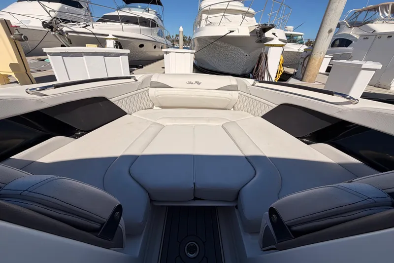 Slide: The Image of 2024 Sea Ray SLX 260 boat interior with luxurious seating at a marina. - 59