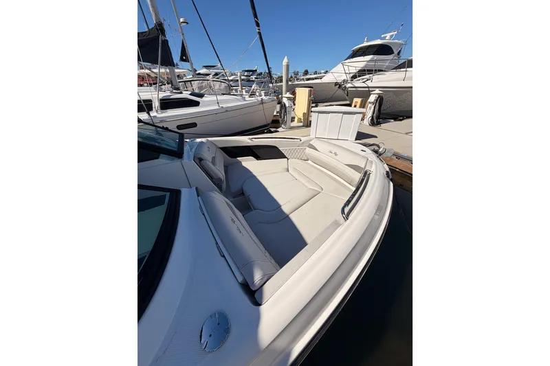 Slide: The Image of 2024 Sea Ray SLX 260 boat with luxurious seating at a marina. - 60