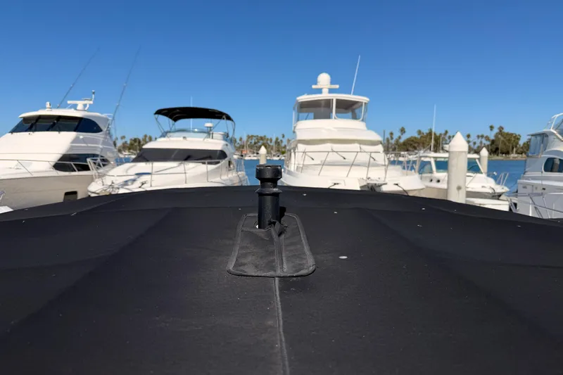 Slide: The Image of 2024 Sea Ray SLX 260 boat docked among other yachts in a marina. - 62