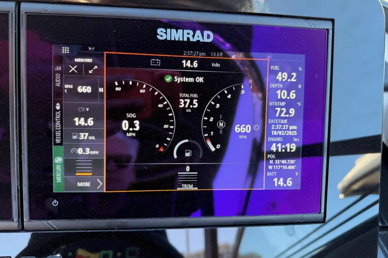 Slide: The Image of Simrad display on 2024 Sea Ray SLX 260 showing system status and navigation data. - 63