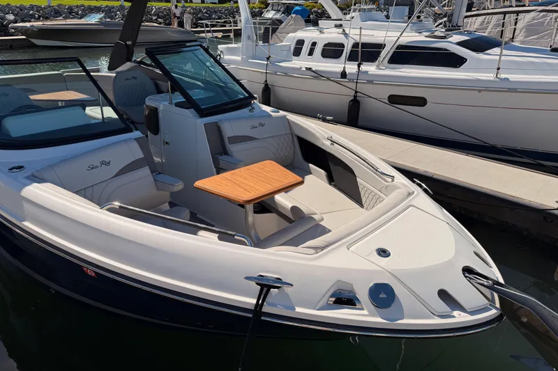Slide: The Image of 2024 Sea Ray SLX 260 boat docked, featuring sleek design and comfortable seating. - 7
