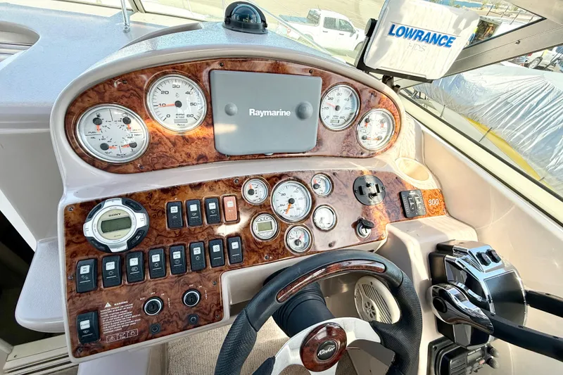 Slide: The Image of 2005 Rinker Fiesta Vee 300 dashboard with gauges, controls, and navigation equipment. - 10