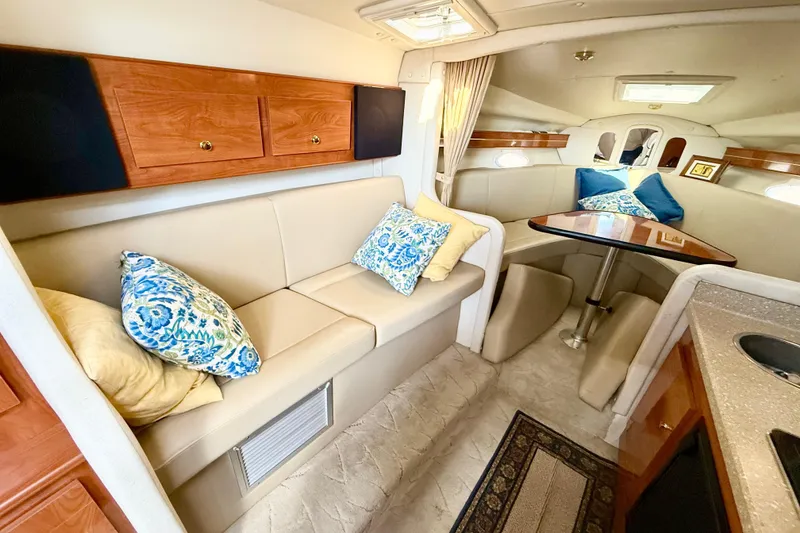 Slide: The Image of Interior of 2005 Rinker Fiesta Vee 300 yacht with cozy seating and elegant decor. - 17