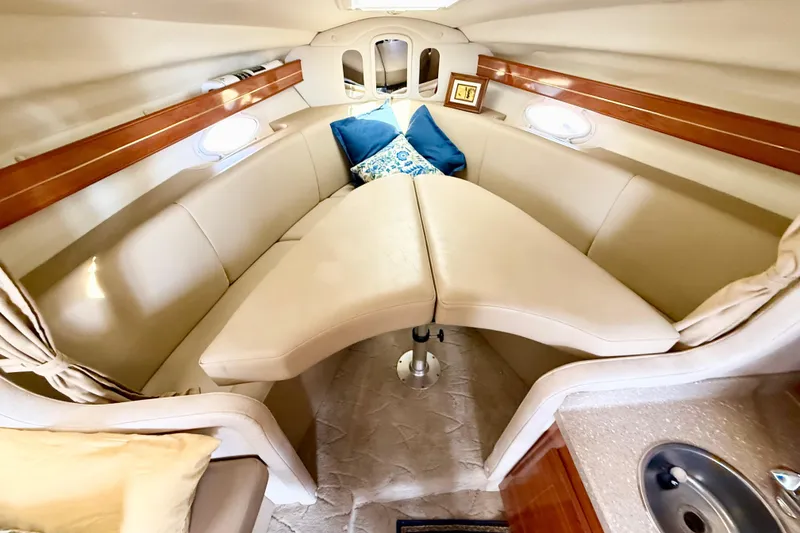 Slide: The Image of Interior of 2005 Rinker Fiesta Vee 300 boat with beige seating and blue cushions. - 22