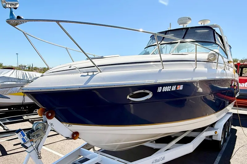 Slide: The Image of 2005 Rinker Fiesta Vee 300 boat on trailer, blue and white exterior. - 27