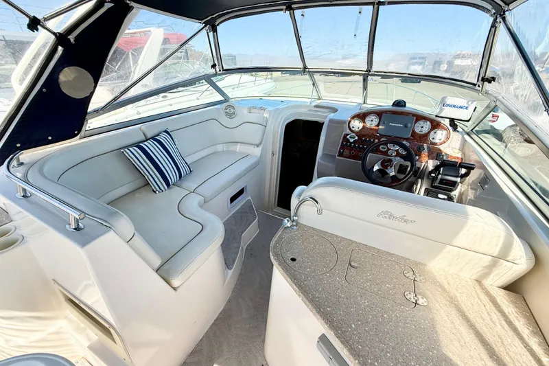 Slide: The Image of 2005 Rinker Fiesta Vee 300 boat interior with helm, seating, and kitchenette. - 6