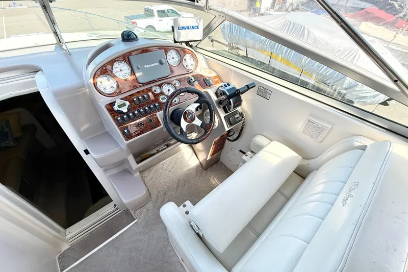 Slide: The Image of 2005 Rinker Fiesta Vee 300 boat cockpit with steering wheel and control panel. - 8