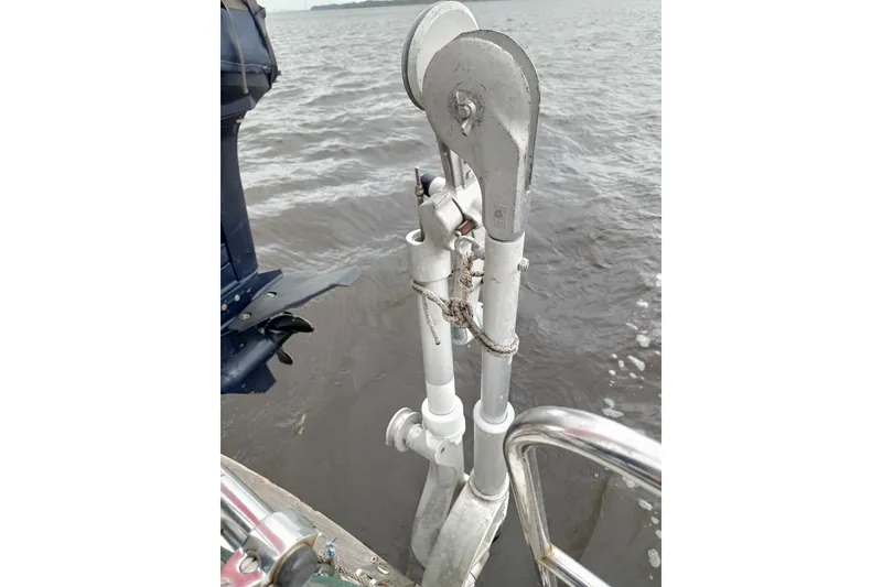 Slide: The Image of Sailboat davit system on a 1978 Pearson 424, over water. - 14