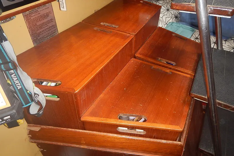 Slide: The Image of Wooden interior steps with storage compartments on a 1978 Pearson 424 sailboat. - 18