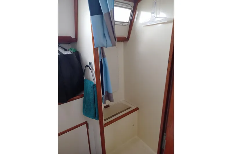 Slide: The Image of 1978 Pearson 424 sailboat interior shower with curtain and towel. - 22