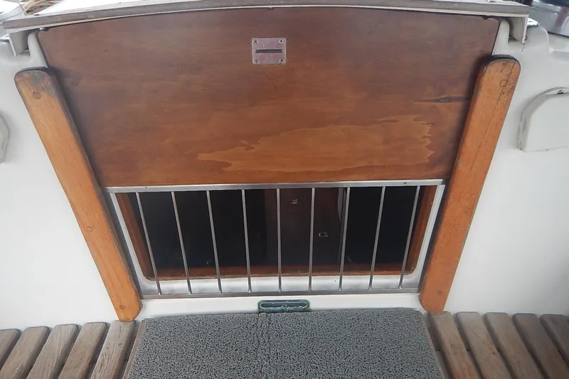 Slide: The Image of Wooden hatch and metal bars on 1978 Pearson 424 sailboat. - 27