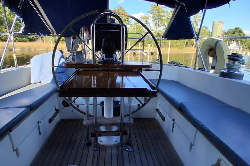 Slide: The Image of Cockpit of 1978 Pearson 424 sailboat with wooden table and steering wheel. - 6