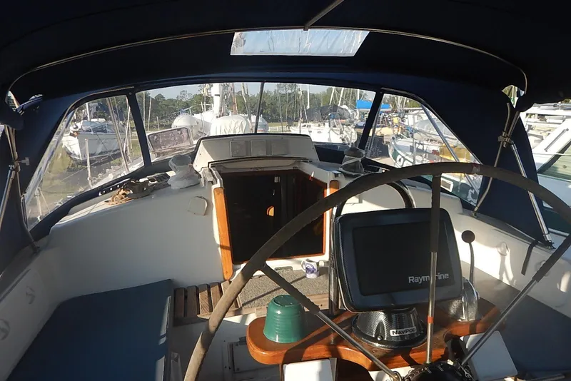 Slide: The Image of Cockpit of a 1978 Pearson 424 sailboat with navigation equipment and steering wheel. - 7