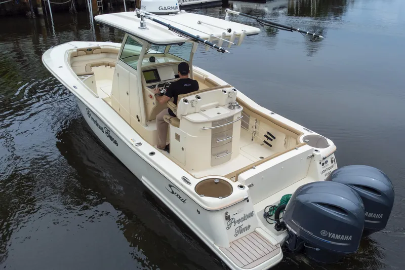 Slide: The Image of 2015 Scout 275 LXF boat with dual Yamaha engines on calm water. - 17