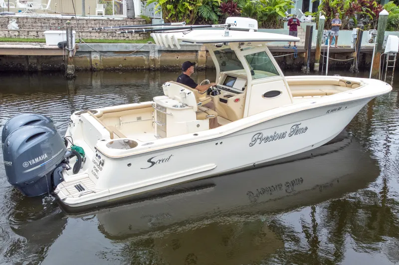 Slide: The Image of 2015 Scout 275 LXF boat with dual Yamaha engines on a calm waterway. - 18