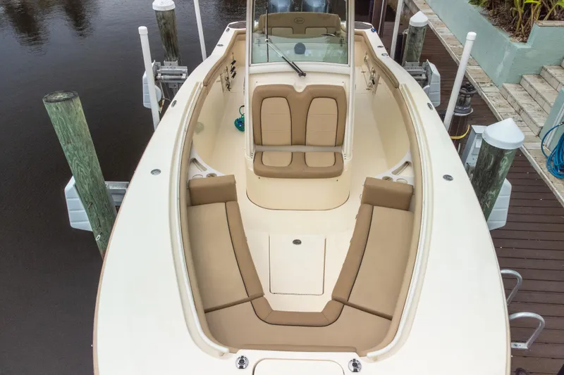 Slide: The Image of 2015 Scout 275 LXF boat with beige seating, docked at a marina. - 28