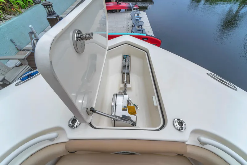 Slide: The Image of Open anchor compartment on 2015 Scout 275 LXF boat at dockside. - 36
