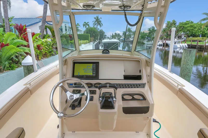 Slide: The Image of 2015 Scout 275 LXF boat dashboard with steering wheel and navigation screen. - 5
