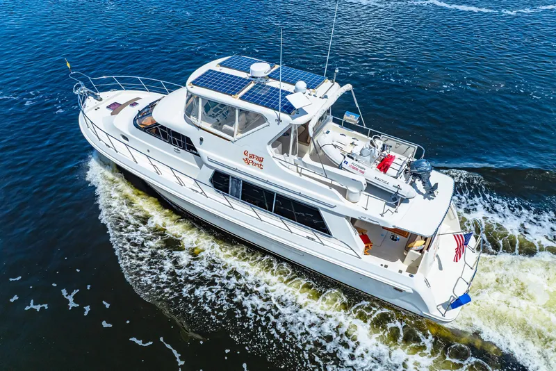 Slide: The Image of 2007 Hampton 558 Pilothouse yacht cruising on open water, aerial view. - 14