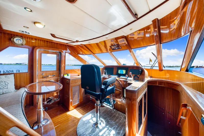Slide: The Image of Luxurious 2007 Hampton 558 Pilothouse interior with polished wood and panoramic windows. - 15