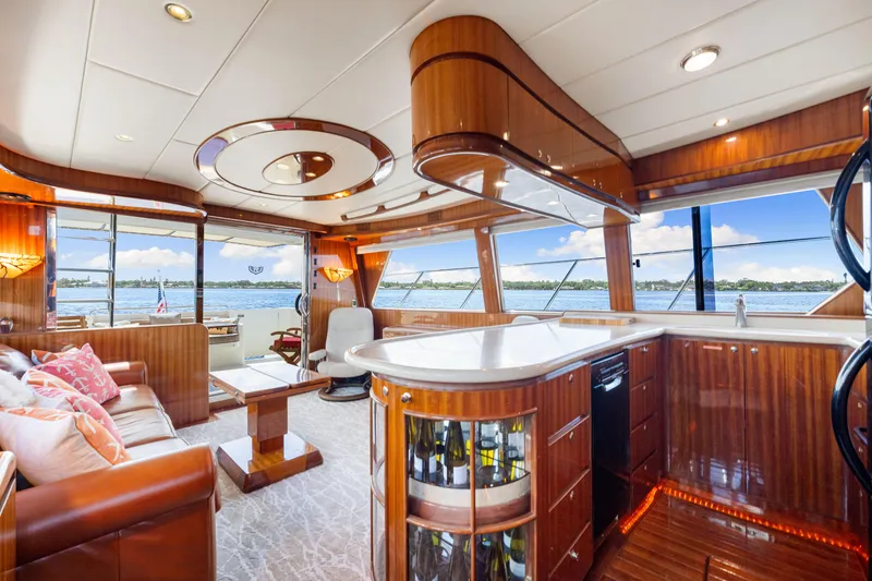 Slide: The Image of Luxurious 2007 Hampton 558 Pilothouse yacht interior with elegant wood finishes and scenic water views. - 27