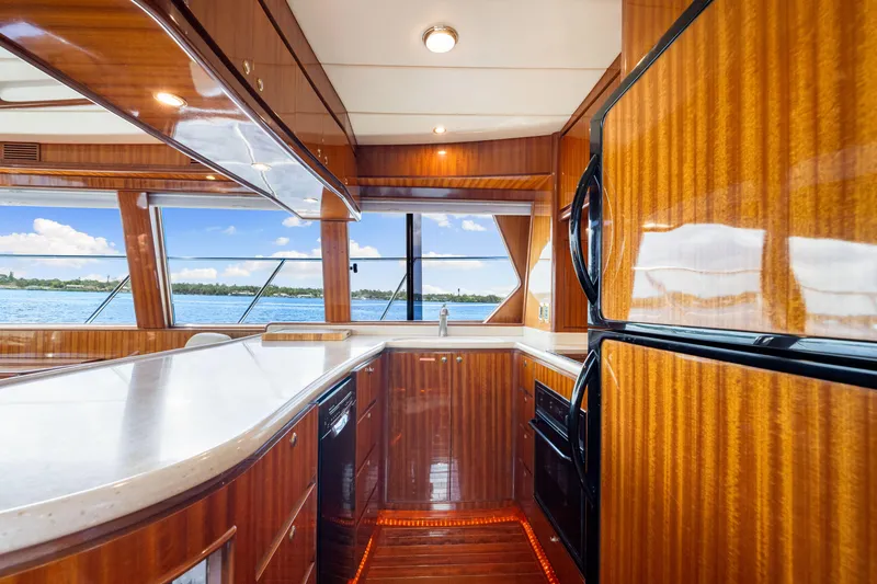 Slide: The Image of Luxurious 2007 Hampton 558 Pilothouse yacht kitchen with wood finish and ocean view. - 28