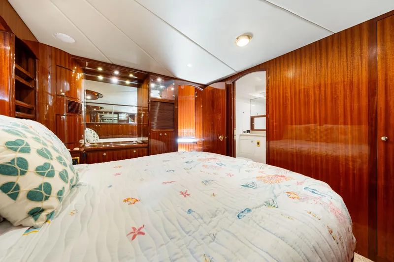 Slide: The Image of Luxurious bedroom interior of 2007 Hampton 558 Pilothouse yacht with wood paneling and cozy bedding. - 33