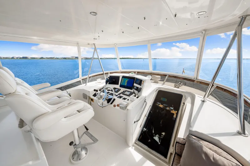 Slide: The Image of Luxurious 2007 Hampton 558 Pilothouse yacht interior with helm and panoramic ocean view. - 43