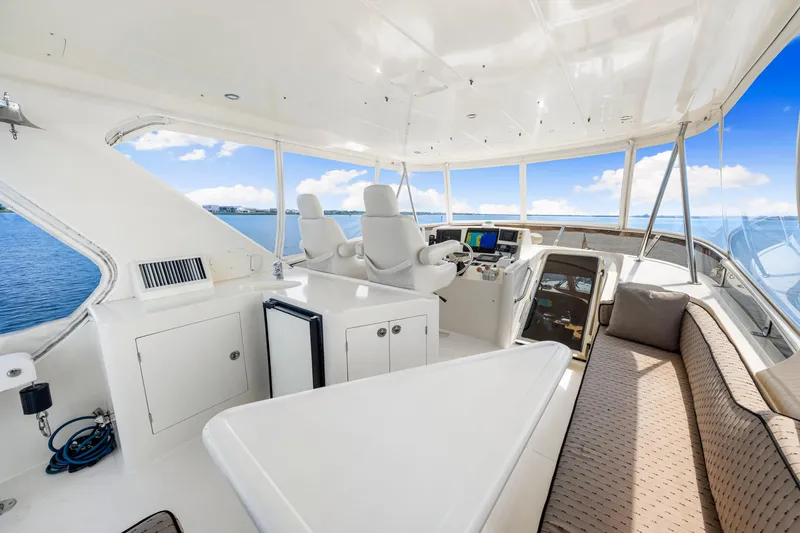 Slide: The Image of Luxurious 2007 Hampton 558 Pilothouse yacht interior with helm, seating, and ocean view. - 48