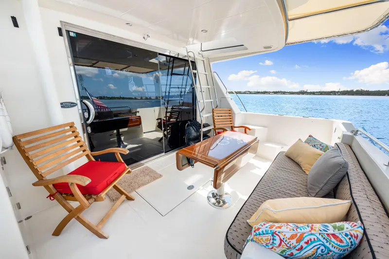 Slide: The Image of 2007 Hampton 558 Pilothouse yacht deck with seating, table, and ocean view. - 55