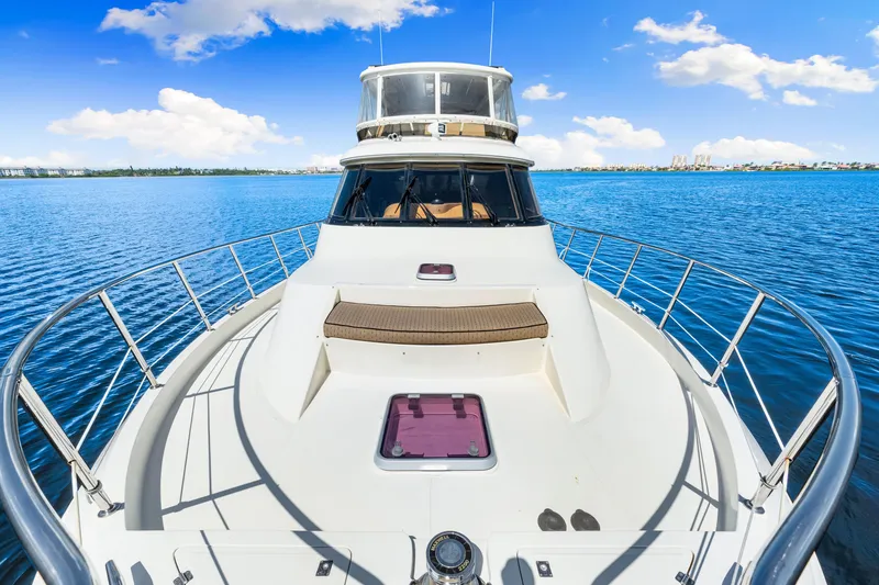 Slide: The Image of 2007 Hampton 558 Pilothouse yacht on calm blue waters under a clear sky. - 62