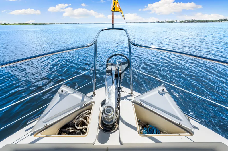 Slide: The Image of Bow view of 2007 Hampton 558 Pilothouse yacht on calm blue waters. - 64