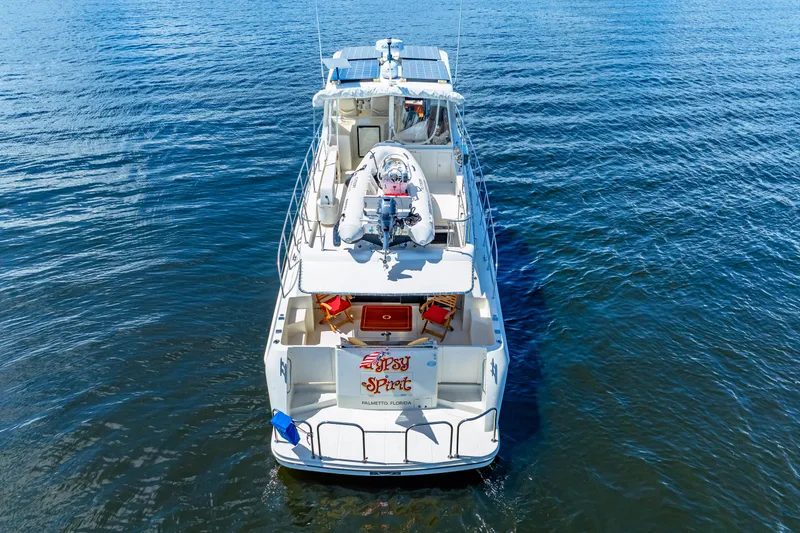 Slide: The Image of 2007 Hampton 558 Pilothouse yacht on calm blue water, aerial view. - 76
