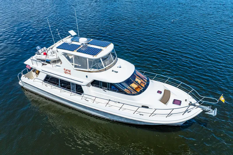 Slide: The Image of 2007 Hampton 558 Pilothouse yacht with solar panels on calm blue water. - 78