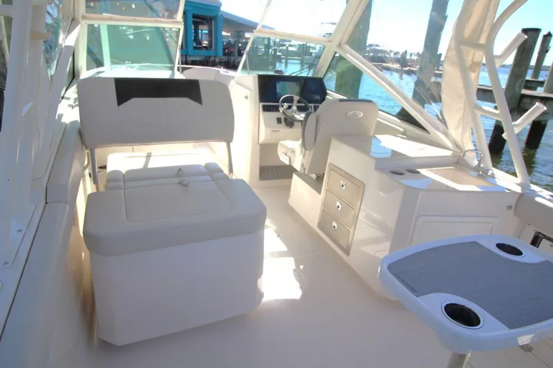 Slide: The Image of 2023 Sailfish 276 DC boat interior with seating, helm, and storage compartments. - 10